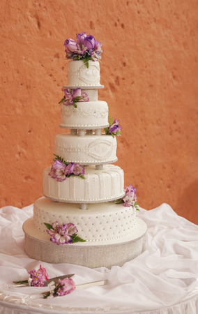 White wedding cake decorated with flowersの写真素材