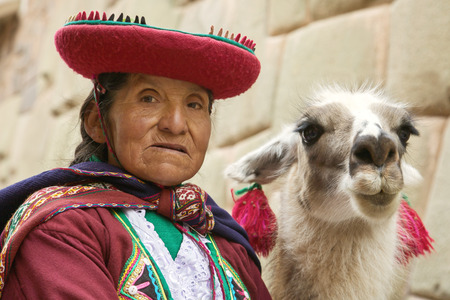 Portrait of old peruvian quechua woman in traditional clothes with llama in Cuscoのeditorial素材