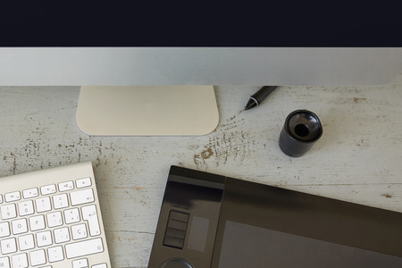 Top View of Computer, Keyboard and Graphic Tablet on Wooden Table.の写真素材