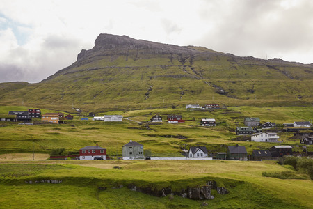 Village in wild and beautiful landscape of Faroe Islands, Denmark.の写真素材