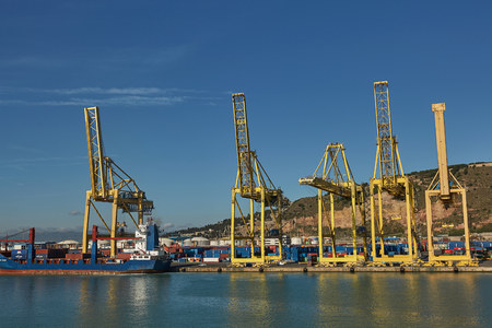 Port crane loads a container on Pier for transportation of import export and business logistic in Barcelona Spain.のeditorial素材