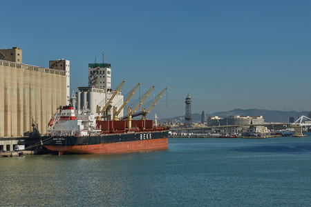Port crane loads a container on Pier for transportation of import export and business logistic in Barcelona Spain.のeditorial素材