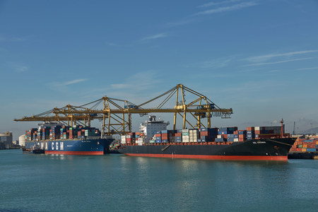 Port crane loads a container on Pier for transportation of import export and business logistic in Barcelona Spain.のeditorial素材