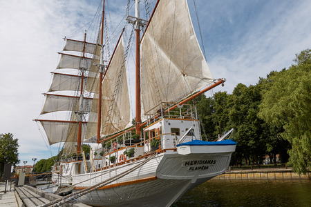 KLAIPEDA, LITHUANIA - JULY 05, 2017: Beautiful white yacht Meridianas- famous symbol of old town of Klaipedain Lithuania. Restaurant on sailing boat, Dane river and park.のeditorial素材