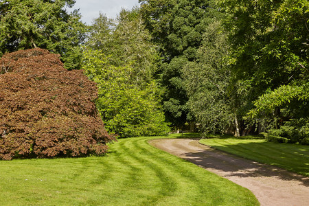 CAWDOR, NAIRN, SCOTLAND, UK - AUGUST 07, 2017: Curved path leading through the park and forest at Cawdor Castle, close to Iverness in Scotlandのeditorial素材