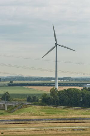 Windmills as wind turbine power generators placed within the countryside of green country of Netherlands.の写真素材