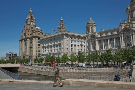 LIVERPOOL, ENGLAND, UK - JUNE 07, 2017: People enjoying the Port of Liverpool Building (or Dock Office) in Pier Head, along the Liverpool's waterfront, England, United Kingdom.のeditorial素材