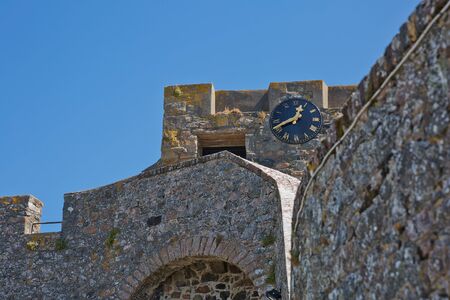 ST. PETER PORT, GUERNSEY, UK - AUGUST 16, 2017: A Clock on the walls of Castle Cornet in St Peter Port, Guernsey, UK.のeditorial素材