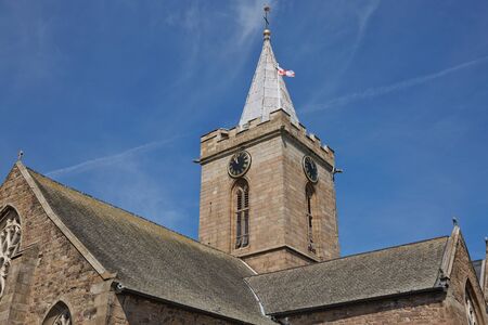 The Town Church is also known as the Parish Church of St Peter Port in Guernsey during Sunny day with blue sky.の写真素材