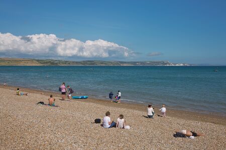 WEYMOUTH, DORSET, ENGLAND, UK - AUGUST 15, 2017: People and tourists enjoying sunny summer day at the beach in Weymouth, Dorset, UKのeditorial素材