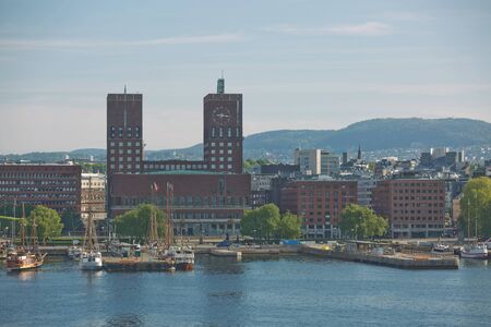 OSLO, NORWAY - MAY 27, 2017: Harbor and red brick City Hall (Radhuset) of Oslo, Norway. City Hall...