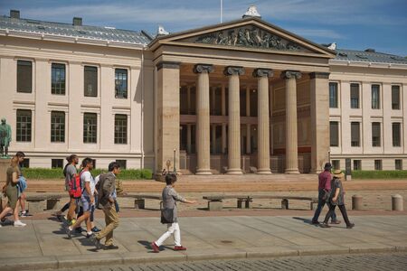 OSLO, NORWAY - MAY 27, 2017: People walking in front of University of Oslo in Norway. Central...