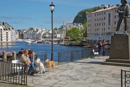 ALESUND, NORWAY - MAY 29, 2017: People enjoying the city life during sunny summer day in Alesund in Norway.のeditorial素材