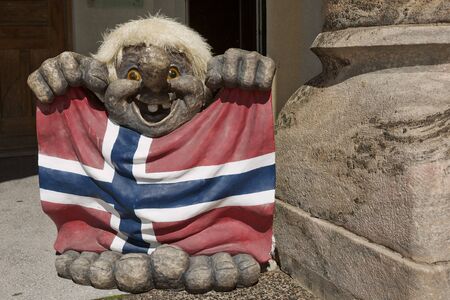 ALESUND, NORWAY - MAY 29, 2017: Troll figure holding a flag in front of a souvenir shop in Alesund, Norway. Troll is a class of being in Norse mythology and Scandinavian folklore.のeditorial素材