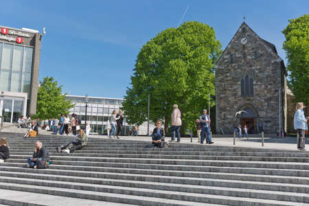 STAVANGER, NORWAY - JUNE 01, 2017: People relaxing and sitting on stairs in front of Stavanger Cathedral in Stavanger Norway.のeditorial素材