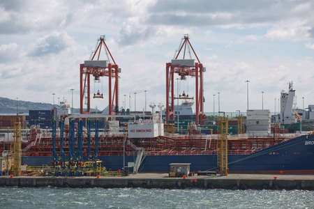 Dublin, Ireland - June 6, 2017: Large industrial cranes loading container ship in Dublin Port in Ireland.のeditorial素材