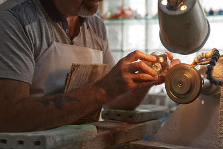 Waterford, Republic of Ireland - June 13, 2017: A craftsman working in the Sculpting Department at the Waterford Crystal factory, in the city of Waterford, Republic of Ireland.のeditorial素材
