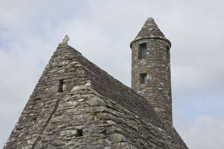 Glendalough, co. Wicklow, Ireland - August 10 2019 :Stone round tower and some ruins of a monastic...