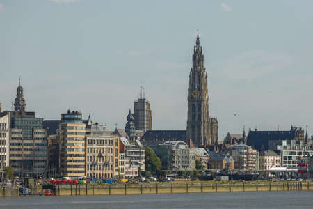 Antwerp, Belgium - June 16, 2017: Cityscape of a port of Antwerp and cathedral of our lady in Belgium over the river.のeditorial素材