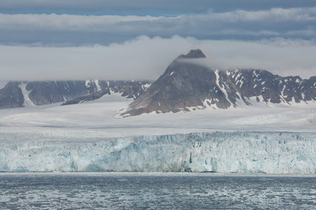 Mountains, glaciers and coastline landscape close to a village called "Ny-Ãlesund" located at 79 degree North on Spitsbergen.の写真素材