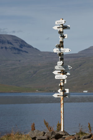 The country location sign at the shore of Eskifjordur town in East region of Iceland.の写真素材