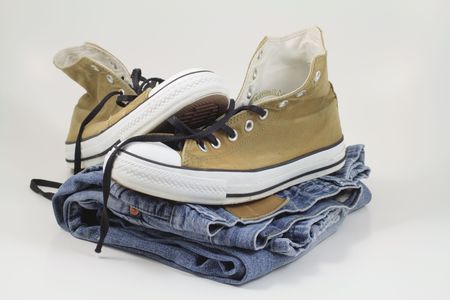 the brown sneakers and blue jeans on white backgroundの写真素材