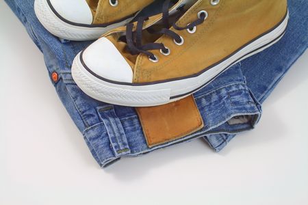 the brown sneakers and blue jeans on white backgroundの写真素材