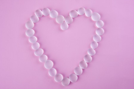 glass heart on pink backgroundの写真素材