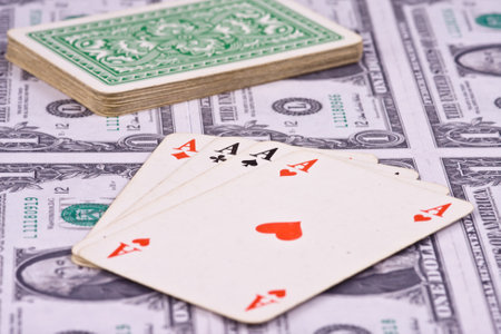playing cards with american money on backgroundのeditorial素材