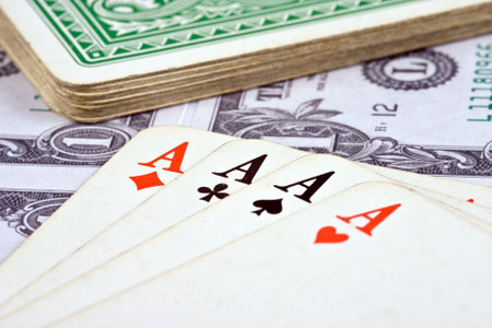playing cards with american money on backgroundのeditorial素材