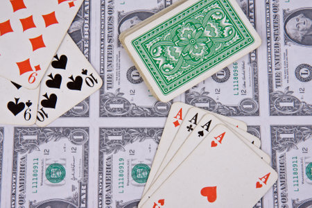 playing cards with american money on backgroundのeditorial素材