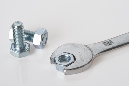 chrome wrench and nuts on white background