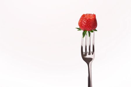 red strawberry on forkの写真素材