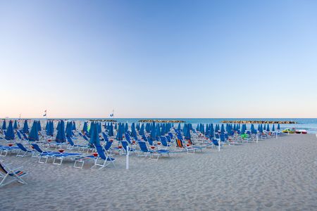 the beach in italy with umbrellas の写真素材