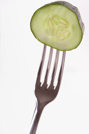 fresh cucumber on the forkの写真素材