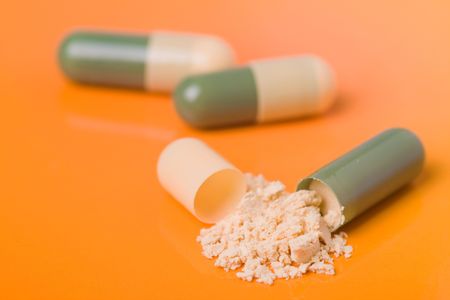the color capsules on orange backgroundの写真素材