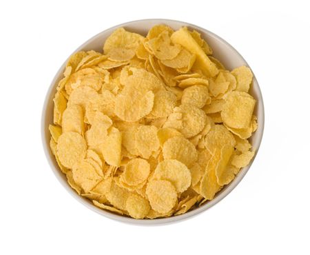 cornflakes in bowl on white backgroundの写真素材
