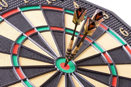 darts in dartboard on white backgroundの写真素材