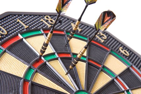 darts in dartboard on white backgroundの写真素材