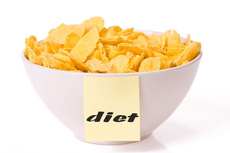 cornflakes in bowl on white backgroundの写真素材
