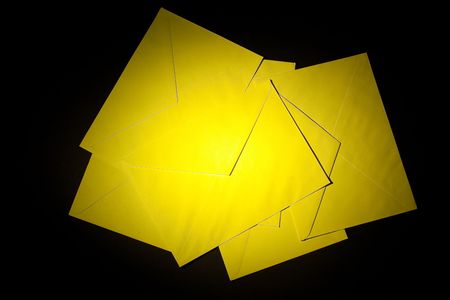 closed envelopes with yellow spot light on black backgroundの写真素材