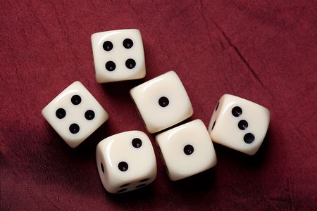 the dice on red fabric
