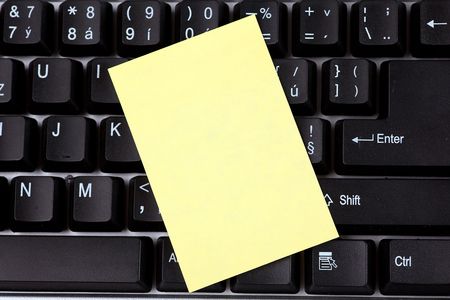 the blank notepaper on black keyboardの写真素材