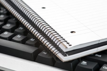 blank notebook on black keyboardの写真素材