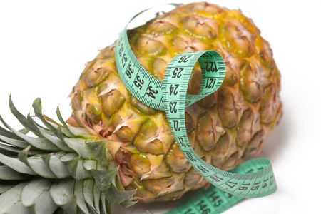 pineapple with measuring tape isolated over whiteの写真素材