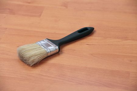 paint brush laying on wooden floorの写真素材