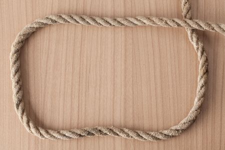 frame make from rope on wooden backgroundの写真素材