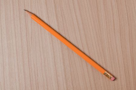 wooden pencil on wooden backgroundの写真素材