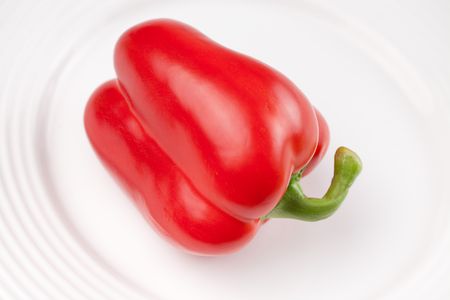 the photo shot of red pepper on white plateの写真素材