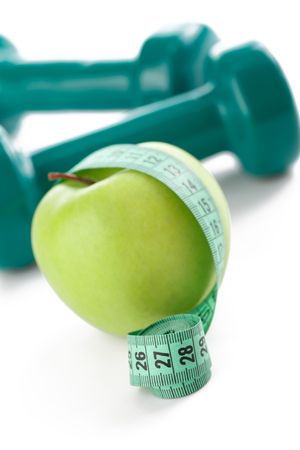 the green apple with measuring tape on white backgroundの写真素材